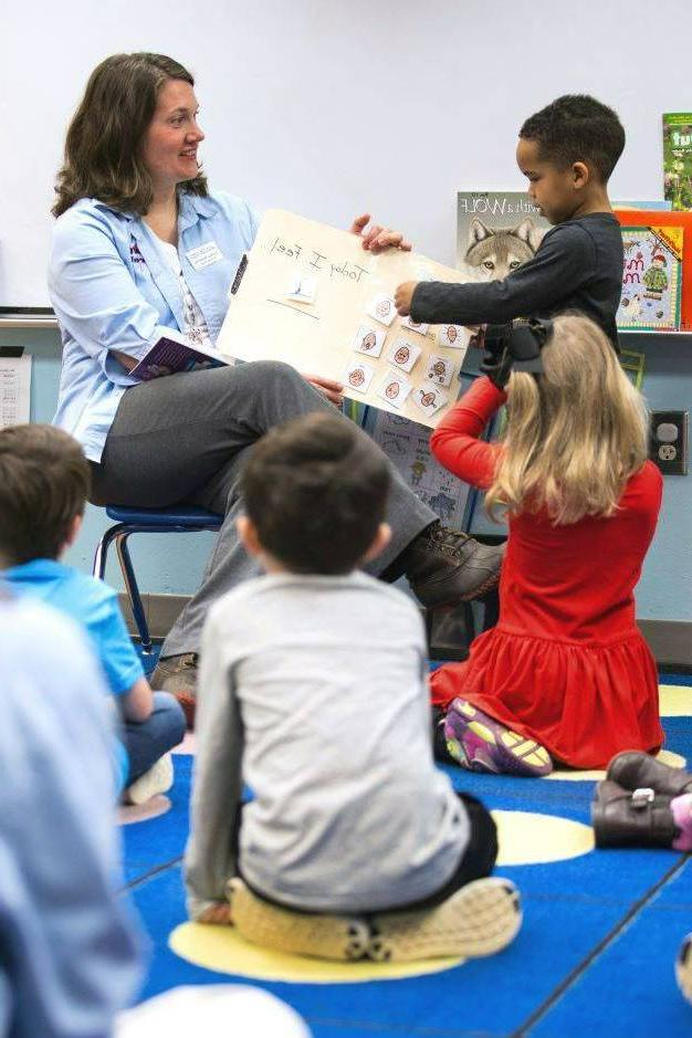 Teacher reading to an elementary school class