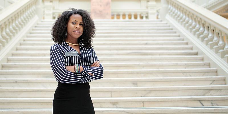 female figure on steps of state capital